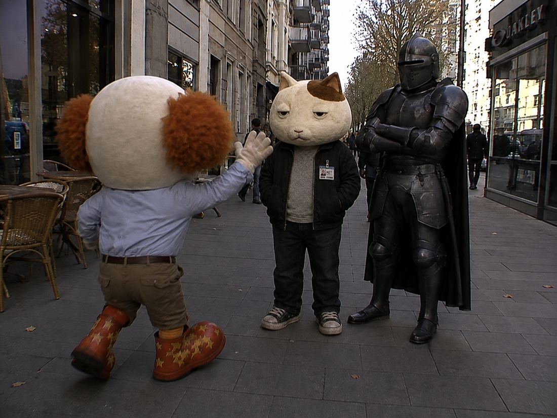 CLOWN high-fiving a cat mascot
